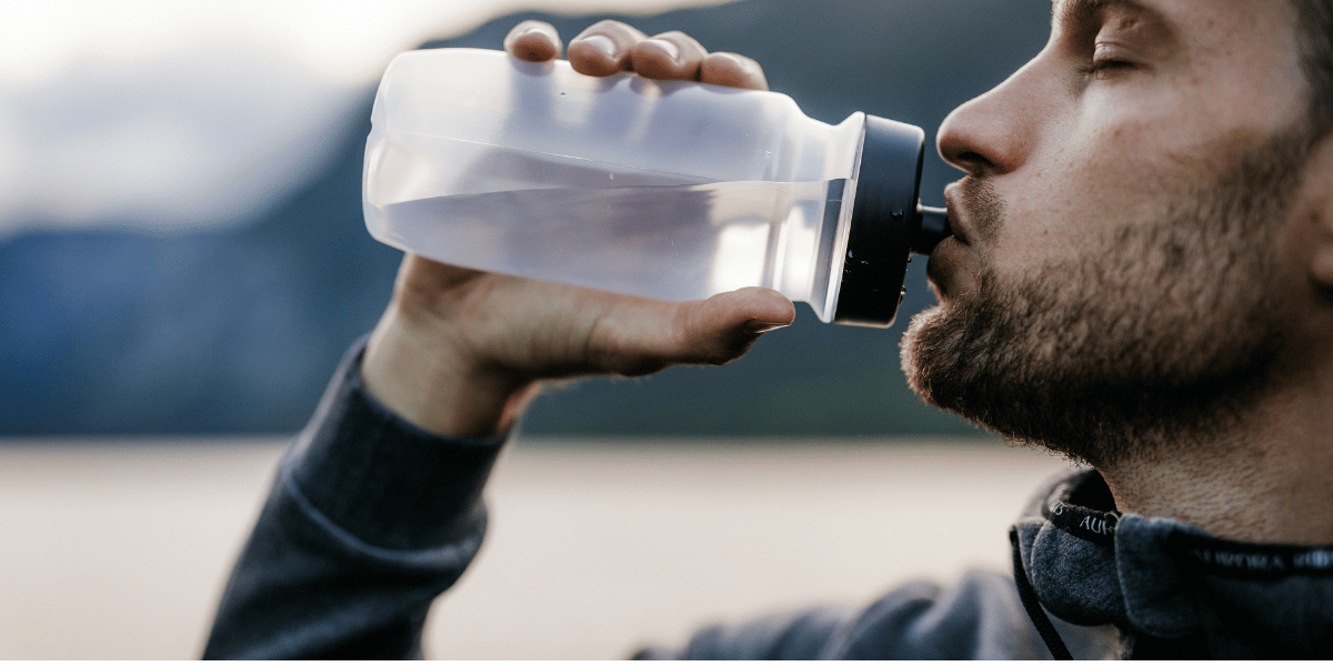 Person drinking from water bottle